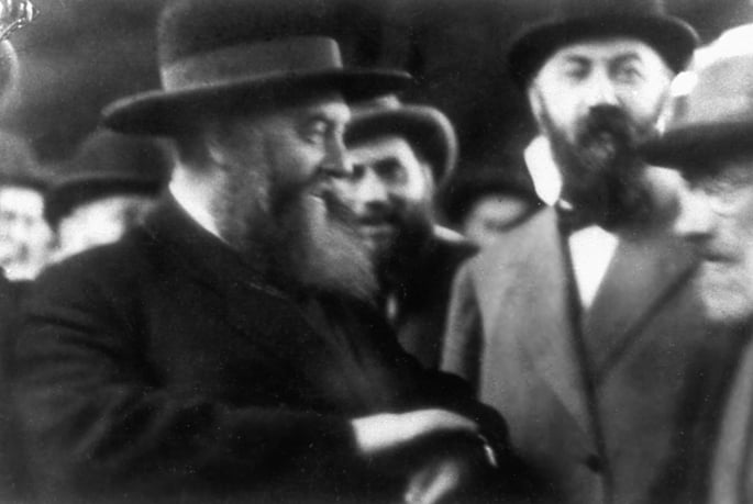 The Sixth Rebbe, Rabbi Yosef Yitzchak Schneersohn, of righteous memory, (left), arrives in Riga, Latvia, on Oct. 21, 1927. Mordechai Dubin, a Lubavitcher Chassid and member of the Latvian parliament who played a key role in gaining the Soviet&#39;s permission for the Rebbe to leave the USSR, is on the right, with bowler hat and bowtie.