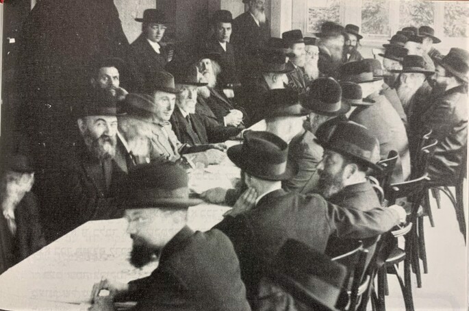 Though a staunch Lubavitcher Chassid, Mordechai Dubin (second from left) was also a member of the world executive of the Agudas Yisrael organization and, for example, a driving force behind the group&#39;s 1937 Knessia Gedolah (Great Gathering) in Marienbad, Germany. Among those pictured with Dubin at this meeting of Agudah&#39;s Moetzet Gedolei HaTorah are Rabbi Zalman Sorotzkin of Lutsk; Rabbi Yehuda Leib Tsirelson of Kishinev; the Sadigura Rebbe, Rabbi Avraham Yaakov Friedman; the Gerrer Rebbe, Rabbi Avraham Mordechai Alter (face turned away from camera); Rabbi Yosef Tzvi Dushinsky; and Rabbi Elchonon Wasserman. At the far left on the near side of the table is Shimon Yitzchak Wittenberg, also a Lubavitcher Chassid who served with Dubin in the Saiema (unrelated to the Reuven Wittenberg mentioned in the article).