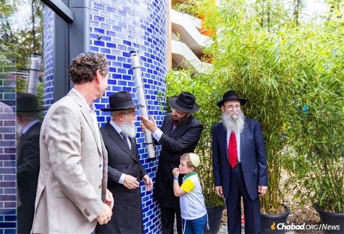 The mezuzah gracing the building’s front entrance, is said to be the largest mezuzah in the world.