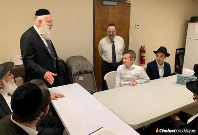 Rabbi Baruch Yehuda Gradon, head of the Merkaz Hatorah Kollel in Los Angeles, congratulates the boys on their accomplishment.