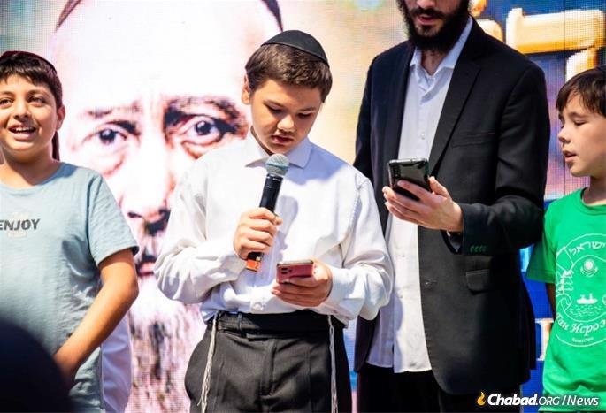 Local Jewish children and yeshivah students from Moscow who traveled to Almaty join for a musical performance at the event. - Photo by Kotlyar