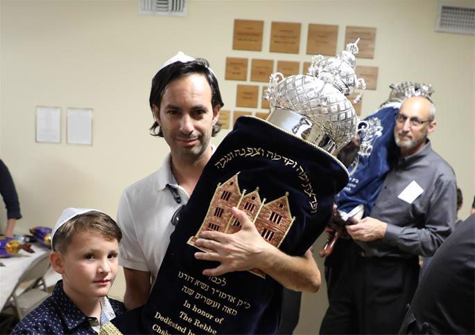Dancing with the Torah (photo not taken on Simchat Torah) - Courtesy Chabad of Clearwater