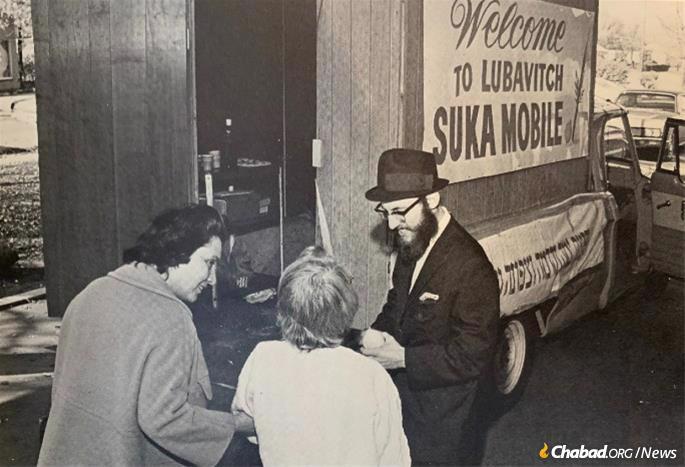 The late Rabbi Yitzchak Meir Kagan, a longtime Chabad-Lubavitch emissary in Detroit, hits the streets in a sukkah-mobile, armed with a lulav and etrog, circa 1970. - Photo: Challenge