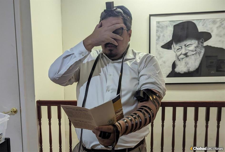 The first person to receive a pair of tefillin in exchange for a commitment to use them every day was Ryan Adams of Long Island, N.Y. Adams said he had wanted to wrap tefillin for a while, but it never felt right, until he saw Rabbi Avromi Super’s post on social media - Photo: Mordechai Lightstone
