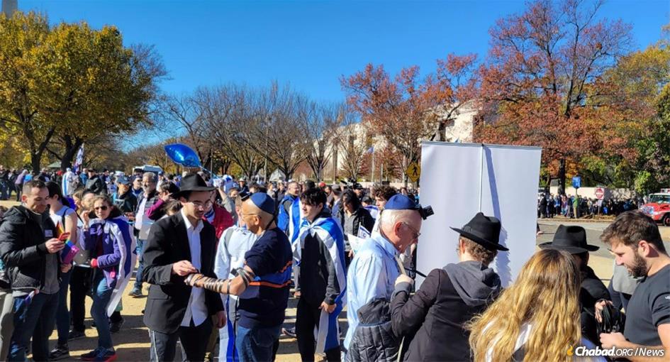 Jewish men put on tefillin in the merit of Israel and her people at dozens of Chabad-Lubavitch mitzvah booths situated on the National Mall in Washington, D.C. - Photo: Joel Petlin