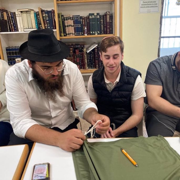 Some of the students were “a little nervous” at first because they had never tied tzitzit before. But after a tying-tzitzit workshop, the students got to work.