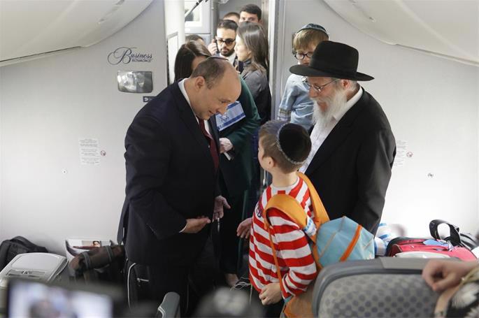 The recent arrivals are greeted by the then Prime Minister of Israel, Naftali Bennett.