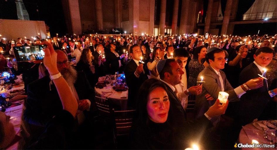 At a gala dinner on behalf of wounded IDF soldiers, 1,500 people lit and lifted candles in the dark room and sang. “In every generation they try to kill us, they try to murder us, but G-d saves us from their hand.” - Photo by Rebecca Howard