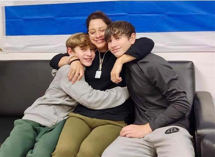 Ranana Yaakov after being reunited with her two sons, Yagil and Or. - Image credit: Ranana Yaakov
