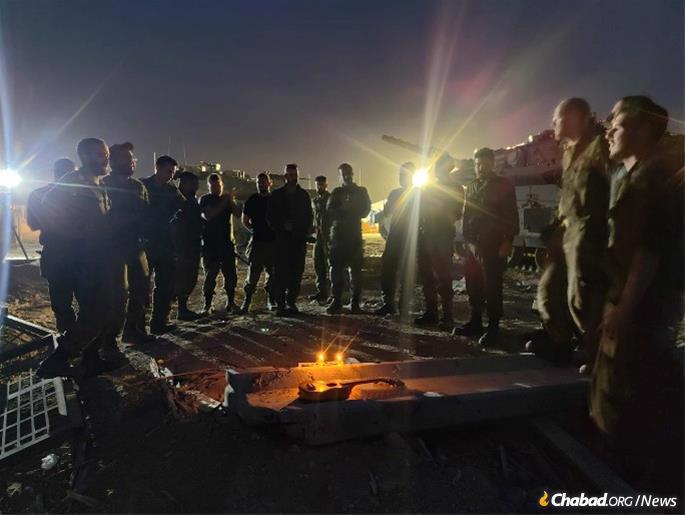Soldiers in the Gaza Strip light a Chanukah menorah. - Photo: Lev Echad