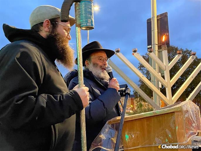 Rabbi Arye Sufrin leads the menorah lighting in Havering, a suburb of London. The lighting was reinstated following a worldwide outcry protesting its cancellation. - Photo: Chabad North London &amp; Essex
