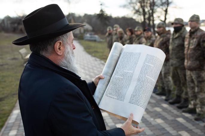 Rabbi Yonatan Markovitch reads the megillah for a group of soliders. - Photo: Chabad-Lubavitch of Kyiv