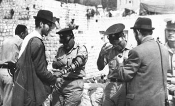 IDF soldiers put on Tefillin at the Western Wall in Jerusalem