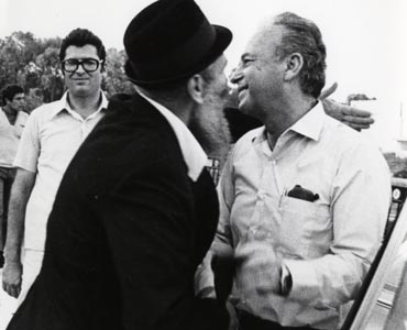 Minister of Defense Yitzhak Rabin is greeted by a Chabadnik as he enters the Bar Mitzvah for the children of fallen Israeli soldiers. 
Photo: Isaac Freidin