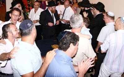Members of the Jewish community of Vietnam dance in welcoming the new new Torah written for the Jewish community in Vietnam. Sixty members of the Jewish community greeted the Torah written for the Chabad-Lubavitch synagogue in Ho Chi Minh, the first synagogue established in the county.