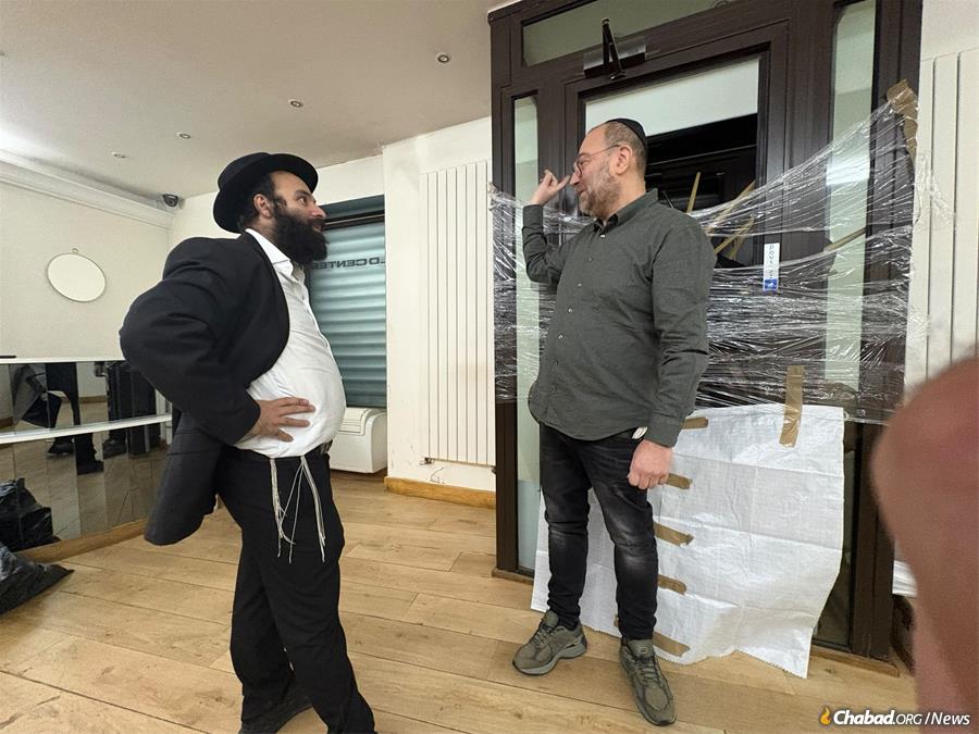 Rabbi Meir Shlomo Lubecki visits a community member whose store was vandalized.