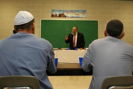 Under the auspices of the Aleph Institute – a prison rehabilitation organization founded in 1981 – 10 Chabad-Lubavitch rabbinical students visited inmates at Dade Correctional Institution in Florida City, Fla. The program, called ''Yeshivah Behind Bars,'' gave students three nine-hour days to learn Jewish texts, pray and eat meals with 13 inmates. In this photo, Rabbi Sholom Ber Lipskar, director of the Aleph Institute and co-director of Chabad-Lubavitch of Bal Harbor, gives a lecture to inmates.