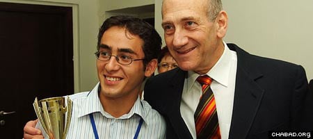 Gabriel Yisraelov, left, celebrates with Israeli premier Ehud Olmert. Photos: Israel Bardugo