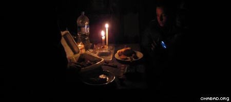 Candle light meal. Chabad-Lubavitch rabbinical students bring food to stranded Israelis in Ica, Peru