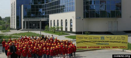 The younger division of Camp Gan Israel of Ekaterinburg, Russia, stands in front of the Chabad-Lubavitch Jewish Community Center.