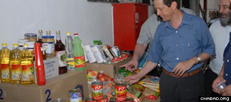Israeli Minister of Welfare and Social Services Yitzhak Herzog reviews a display of the items currently being readied for shipment to needy families in advance of the High Holidays.