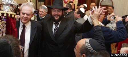 Rabbi Shmuel Raskin of Budapest’s Keren-Or Chabad Israeli Center dances with Yosef Priel, the benefactor who underwrote the synagogue’s recent renovations, at a celebration marking the arrival of a new Torah scroll.
