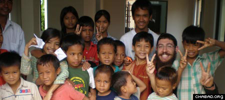 Rabbi Saadya Notik, second from right, and other rabbinical students visited a newly-built orphanage during their time in Cambodia.