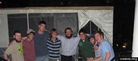 Rabbi Zev Johnson, center, co-director of the Chabad House at the University of Texas, stands with members of the university’s Alpha Epsilon Pi fraternity who helped build a campus sukkah.