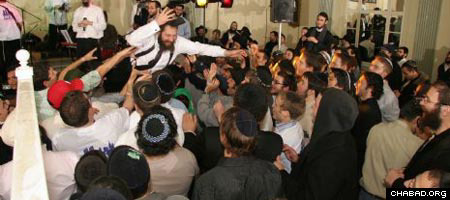 Rabbi Dov Yona Korn, co-director of the Chabad House serving New York University, stage dives during a concert at last year&#39;s International Student Shabbaton &amp;amp; Conference.