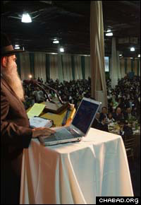 Rabbi Moshe Kotlarsky leads the traditional roll call of Chabad-Lubavitch emissaries.