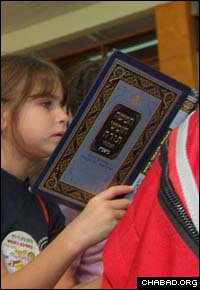 A second grader learns the first few verses of the book of Genesis.