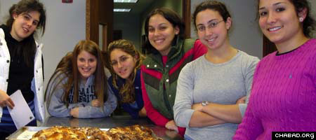 Girls at Binghamton University in New York prepare for Shabbat by baking challah.