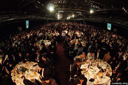 Hundreds of circular tables lined the Pier 94 ballroom as close to 4,500 Chabad-Lubavitch emissaries, their parents and supporters enjoyed an evening of elegant food, inspiring speeches and moving video presentations as part of the grand banquet at the International Conference of Chabad-Lubavitch Emissaries. (Photos: Israel Bardugo)