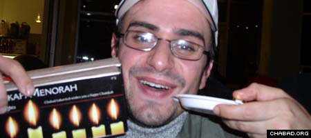 A student at Brandeis University shows off his free menorah.