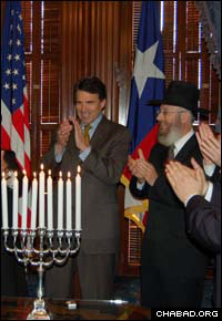 Texas Gov. Rick Perry, left, welcomed a delegation of 16 Chabad-Lubavitch rabbis to his capitol office for a Chanukah reception.
