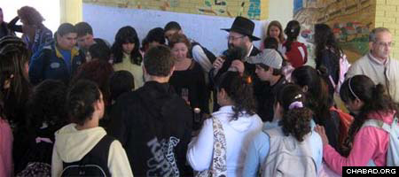 Children and parents gather at a local school for a menorah lighting run by Chabad-Lubavitch of Sderot.