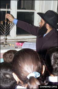 Rabbi Ovadya Isakov lights the Chanukah menorah in his Derbent, Russia, home.