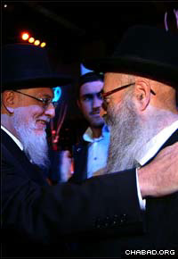 Rabbi Shmuel Azimov, right, director of Chabad-Lubavitch of Paris, embraces Chief Rabbi of France Haim Yossef Sitruk. (Photos: Mendy Benhamou)