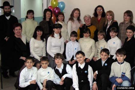 The new residents of the Planet of Childhood home for children of impoverished families in Krivoy Rog, Ukraine, pose for a picture with the staff of the city’s Or Avner Chabad Day School, which administers the facility. The 12 children will take classes at the school, which celebrated the new wing’s grand opening last week. Community member Mikhail Marmer made the project possible.