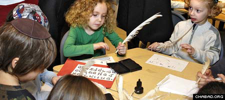 Children from the Preschool of the Arts in New York City try their hands at writing Hebrew letters the way a scribe does during a ceremony marking the start of a Torah scroll in memory of a toddler who died 20 years ago.