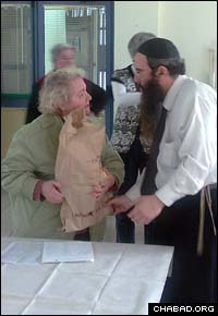 Rabbi Yehuda Butman, co-director of Chabad-Lubavitch of Ramat Hasharon, Israel, delivers food to the city’s Holocaust survivors.