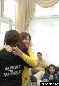 Bassie Shemtov, right, co-founder of the Friendship Circle, hugs incoming international volunteer president Deena Naomi Berlin.