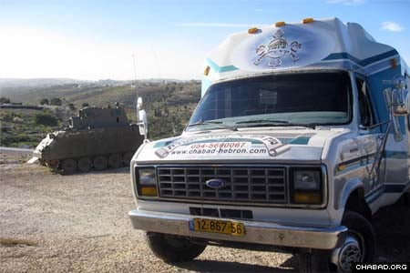A Chabad-Lubavitch “synagogue on wheels” from the Israeli city of Hebron arrives at an IDF outpost to bring some Purim happiness to Israel’s frontline soldiers.