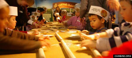 Visitors to the Jewish Children&#39;s Museum roll out matzah dough during a pre-Passover workshop.