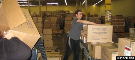 Workers at the Aleph Institute, a Chabad-Lubavitch organization based in Surfside, Fla., that provides for the needs of Jewish prisoners and military personnel, prepare shipments of Passover supplies.