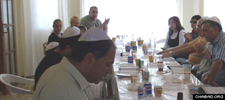 Jewish residents and tourists in Northern Cyprus enjoy a community meal organized by Rabbi Chaim Hillel and Devorah Leah Azimov.