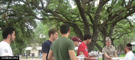 Students at Texas A&M University, including one of the school’s cadets, line up to receive Passover food from Rabbi Yossi Lazaroff, co-director of the Chabad Jewish Student Center.
