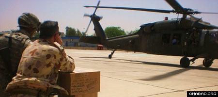 Soldiers in Iraq prepare to load a helicopter with Passover supplies.