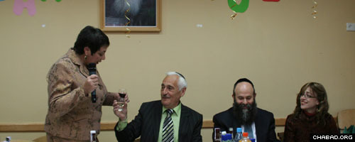 Seated next to Chabad-Lubavitch Shmuel Kaminetski, second from right, chief rabbi of Dnepropetrovsk, Ukraine, Semyon Kaplunsky, the first director of the city’s Ohr Avner Levi Yitzchak Schneerson Day School accepts a toast to his 70th birthday.