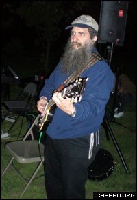 Chabad-Lubavitch Rabbi Menachem Schmidt plays the guitar at a Lag B’Omer celebration in Philadelphia hosted by Chabad-Lubavitch of Northern Liberties.